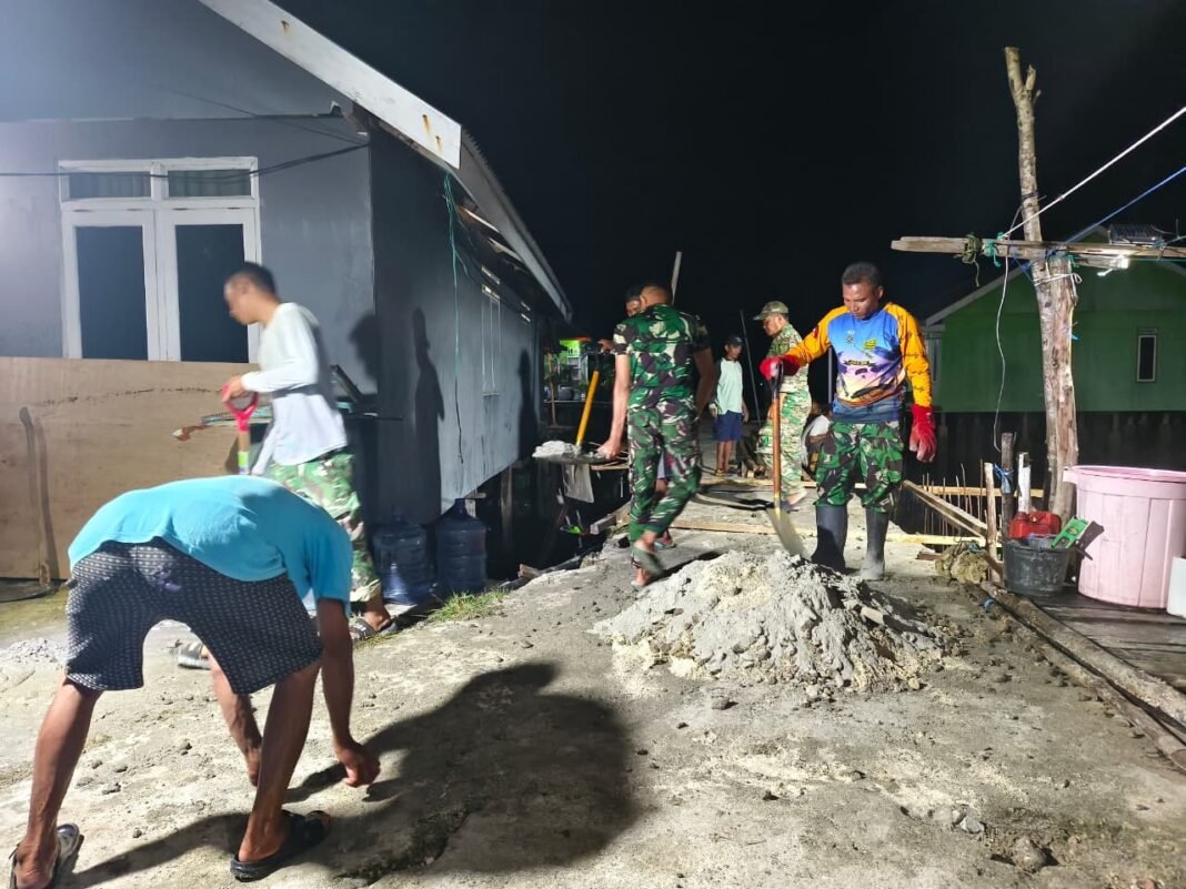 Kerja Sama Kades Umbele dan Satgas TMMD dalam Gotong Royong Pembangunan Malam Hari
